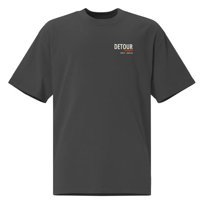 Cutline Oversized Tee in Faded Black, AS Colour 5082, front view. Genuine Printful garment mockup.