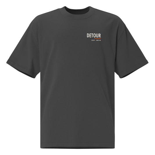 Cutline Oversized Tee in Faded Black, AS Colour 5082, front view. Genuine Printful garment mockup.